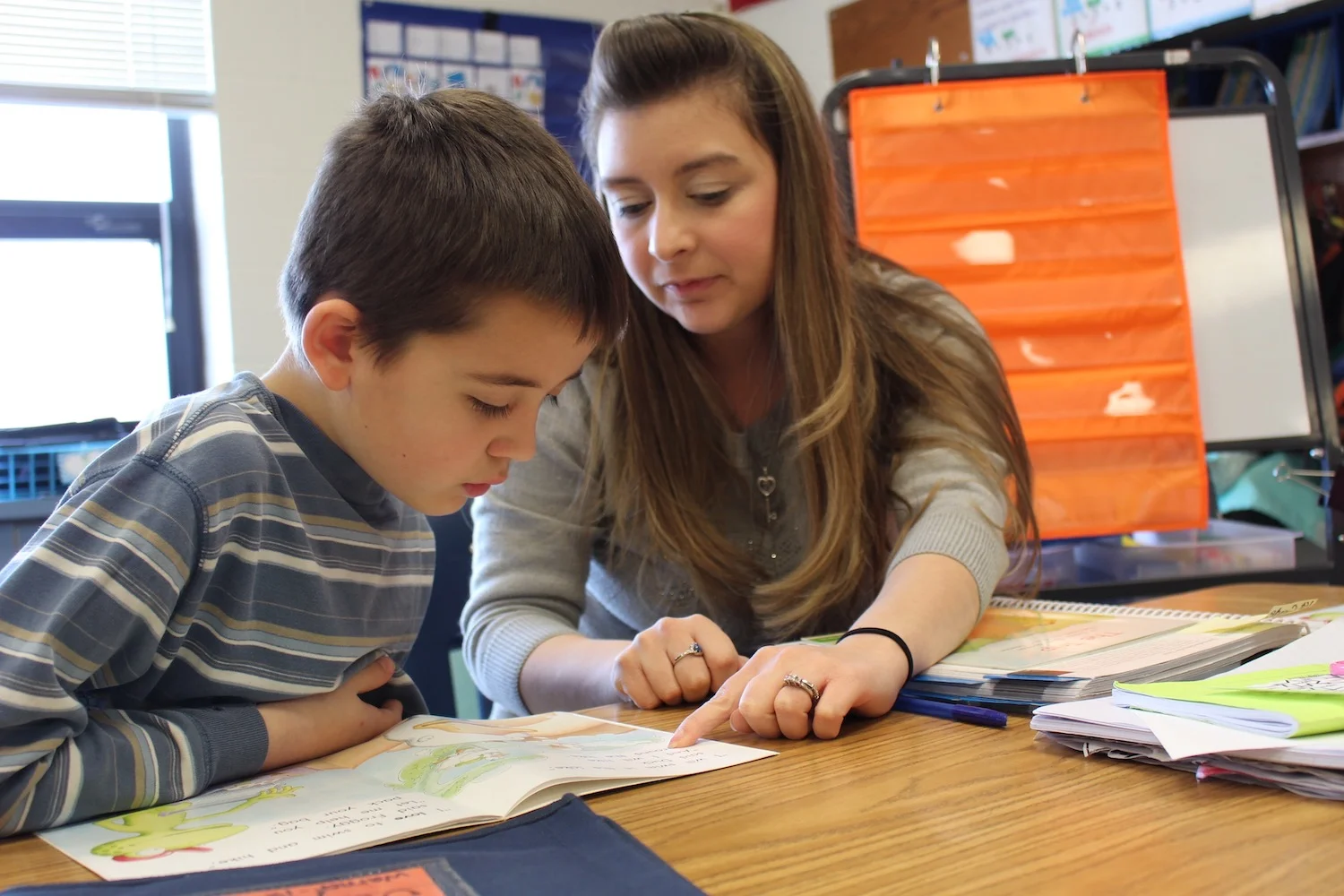 Teacher working one-on-one with a student.