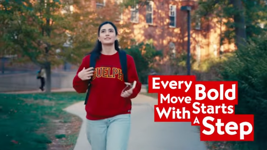 Young woman walking outdoors on a campus or park path with trees and buildings in the background, wearing a red sweatshirt, carrying a backpack, holding a phone, with the quote 'Every Bold Move Starts With A Step' displayed in bold red and white text.