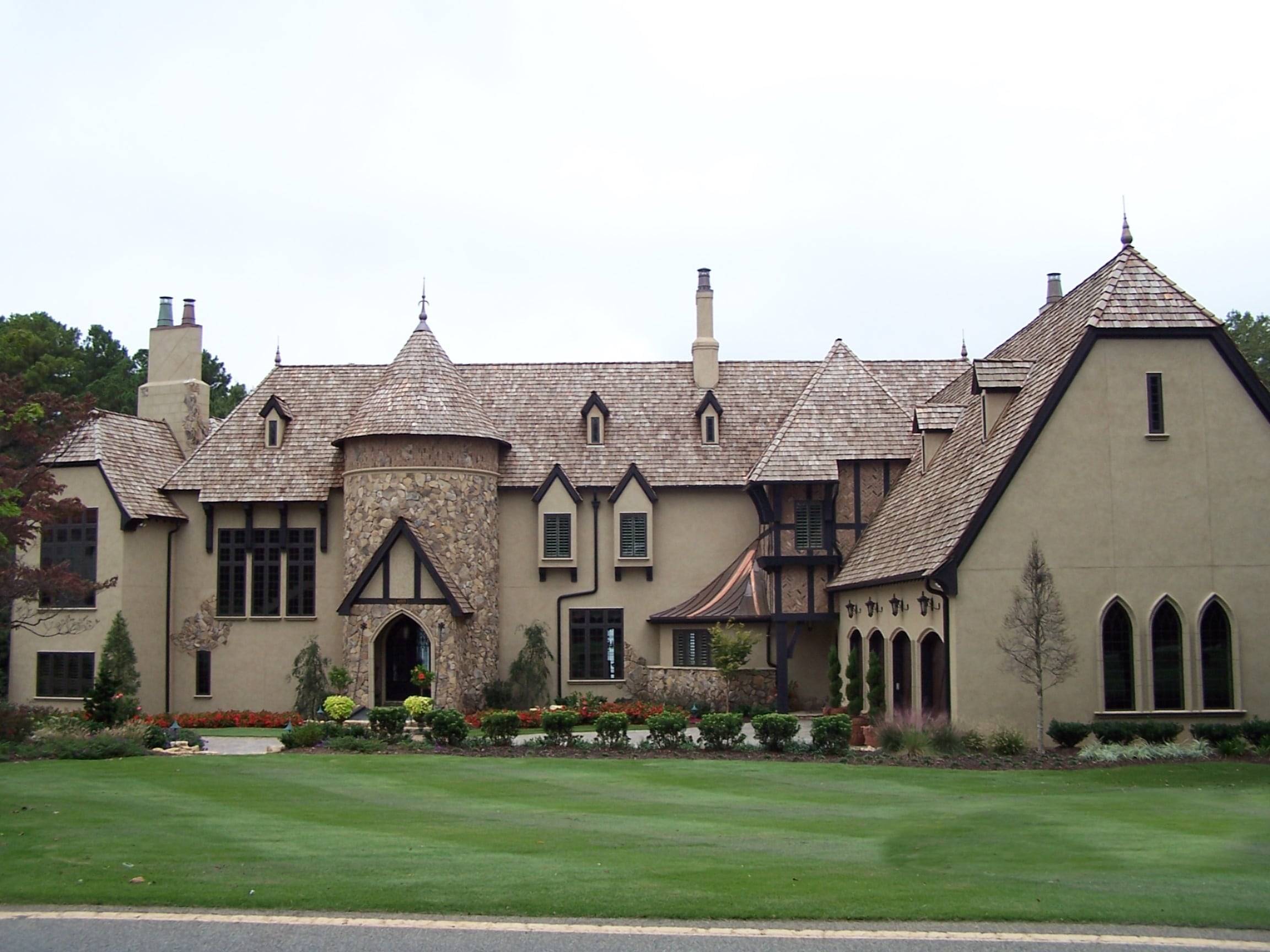 Beautiful Old World home with stucco and stone. Cedar shake roof adds to the old world charm.