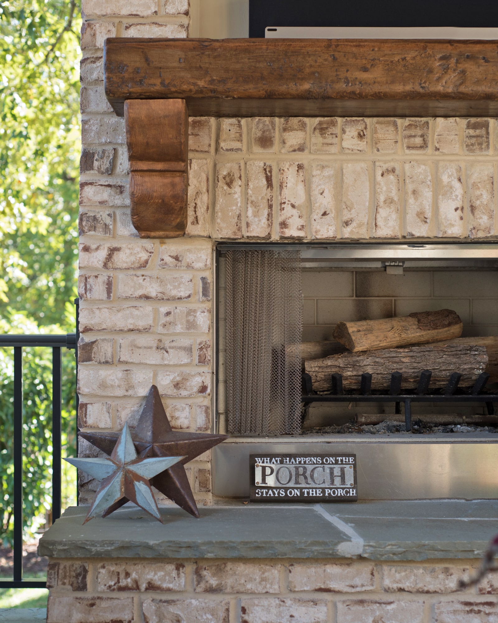 Rustic wood mantel on the brick fireplace. We recessed a niche above to hold the TV.