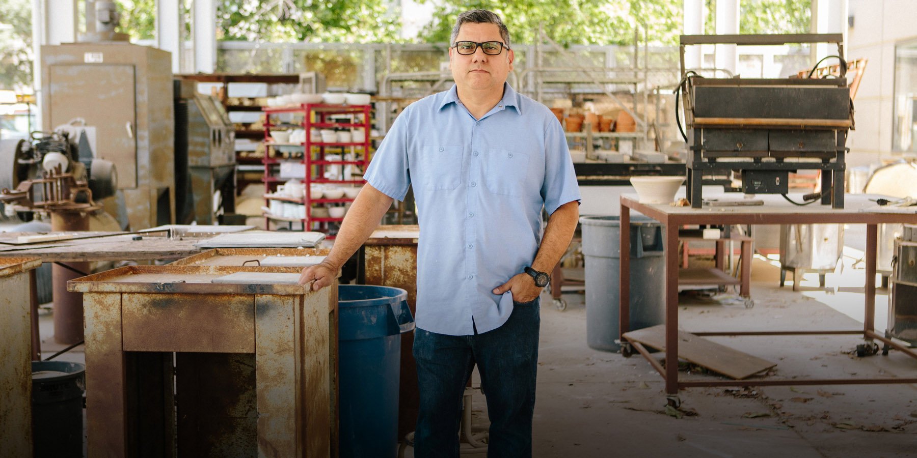 Photo of Ed Gomez curator of MexiCali Biennial in his art studio at CSUSB.
