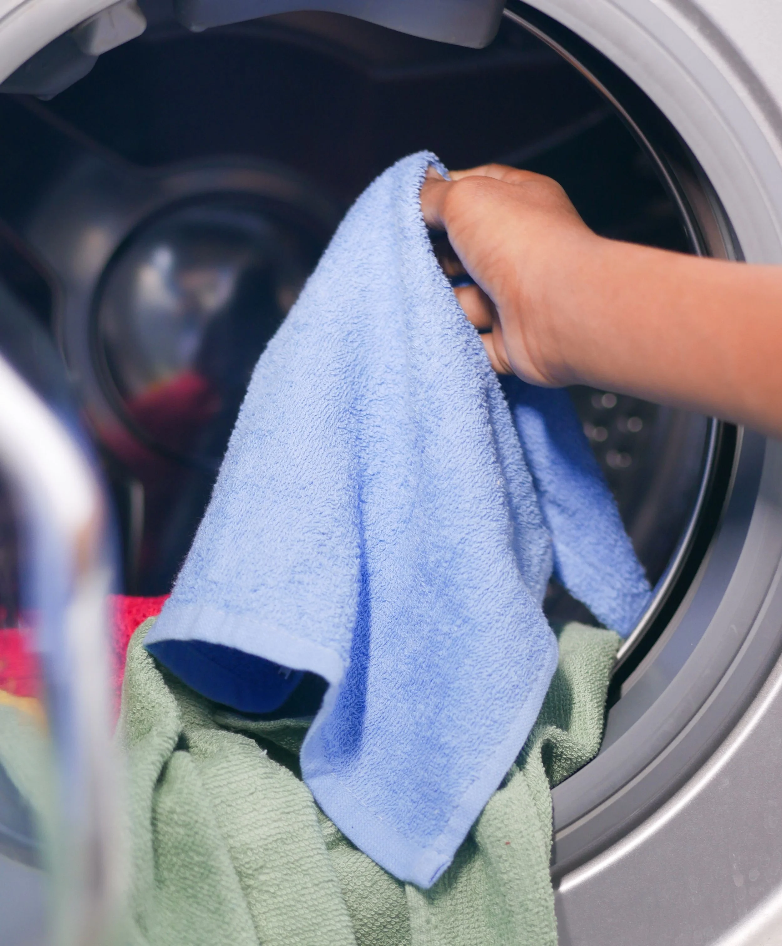 Customer dropping off laundry for professional wash-dry-fold service at Grandview Coin Laundry in Grandview, Missouri