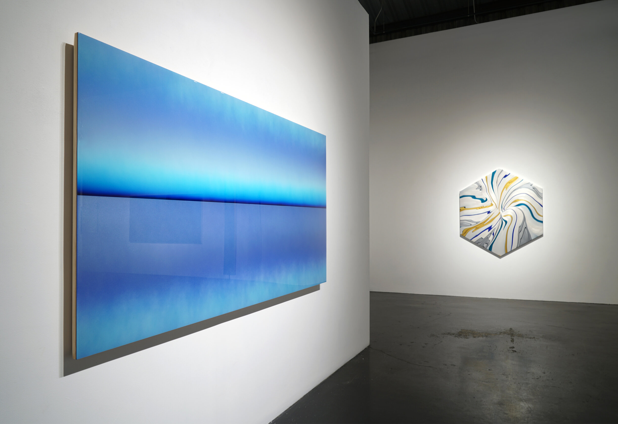  Casper Brindle, Middle Pacific, 2020, acrylic, automotive paint and resin on panel, 48" x 96".    Andy Moses, Geodynamics 1216, 2020 acrylic on canvas over hexagonal shaped wood pale, 60” x 52” 