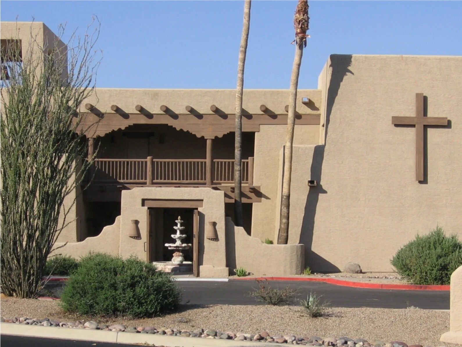 Fountain side of building with cross