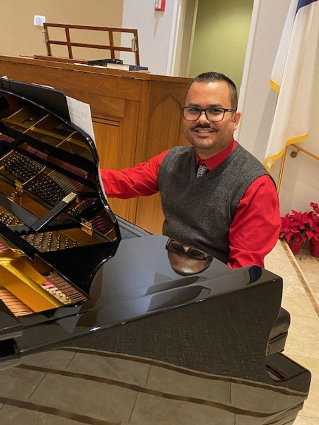 Dr. Rodriquez at the piano