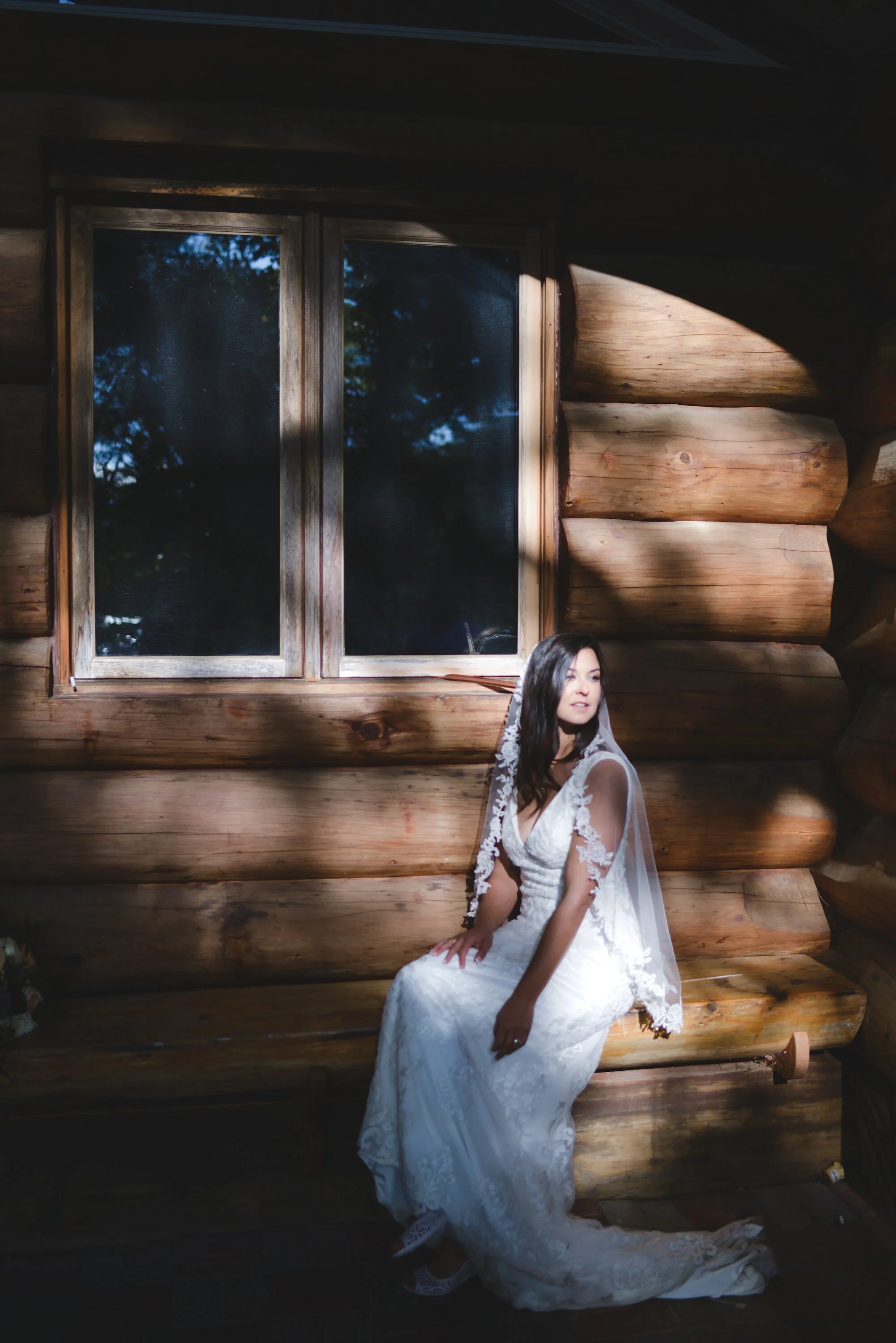 Bride sitting in front of a cabin at niagara on the lake
