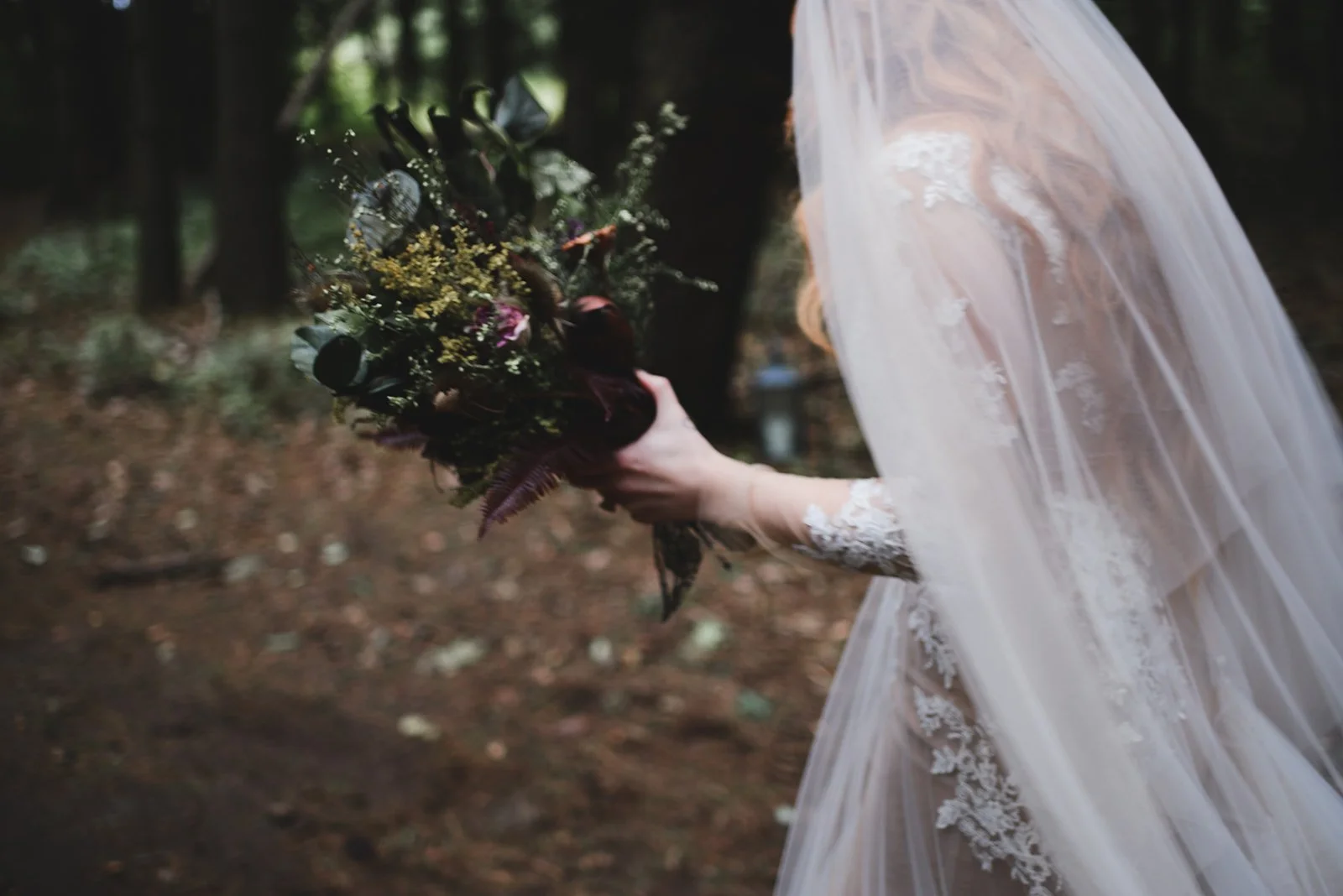 bride walking with a bouquet at whispering springs