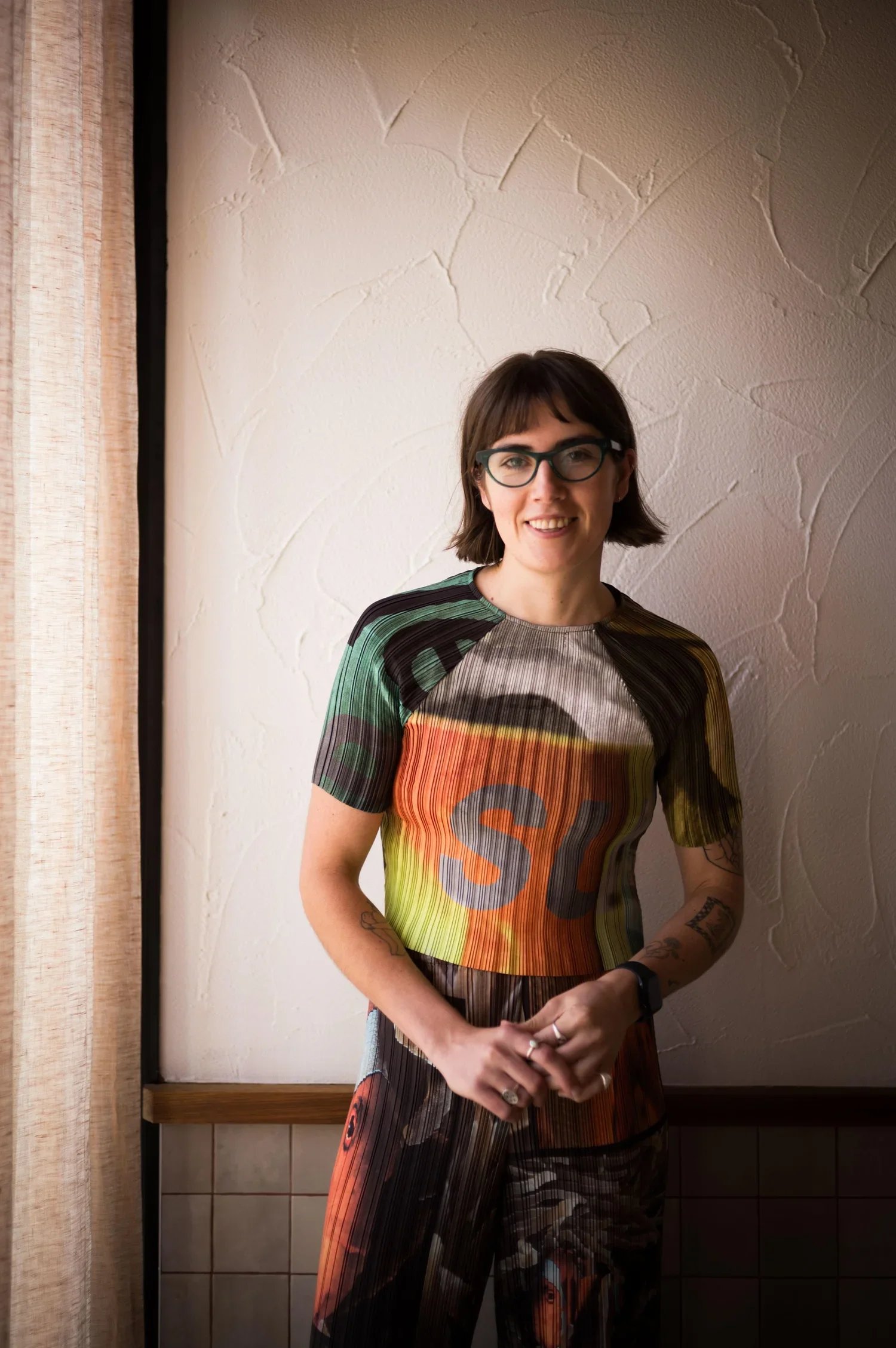 Woman wearing glasses smiling to camera