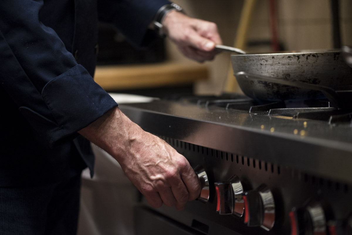 closeup-hand-turning-on-stove-burner.jpg