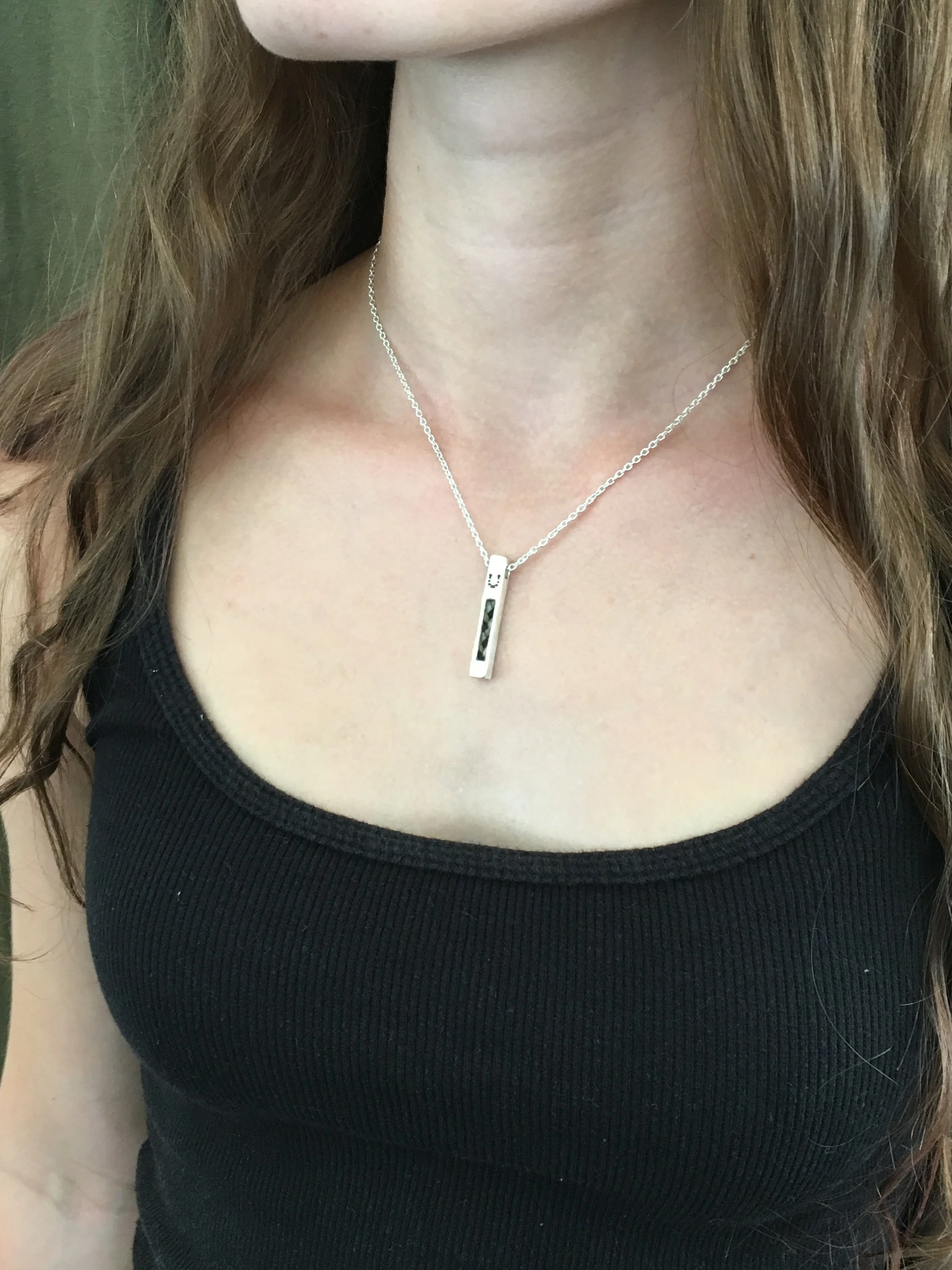 Vertical Horse Hair Pendant With Stone Setting Worn on a Woman's Neck
