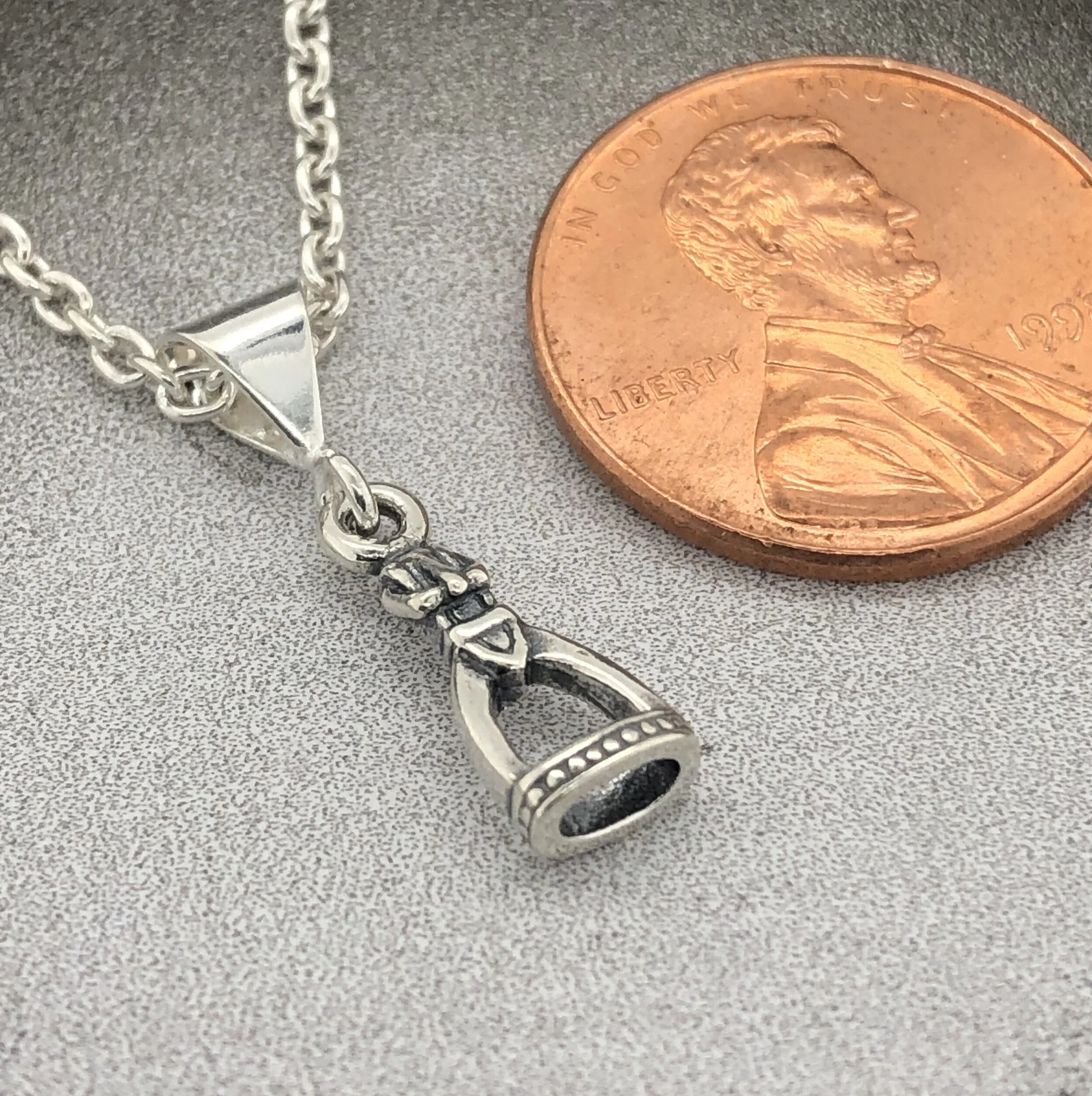 tiny detailed stirrup pendant w: penny.jpg