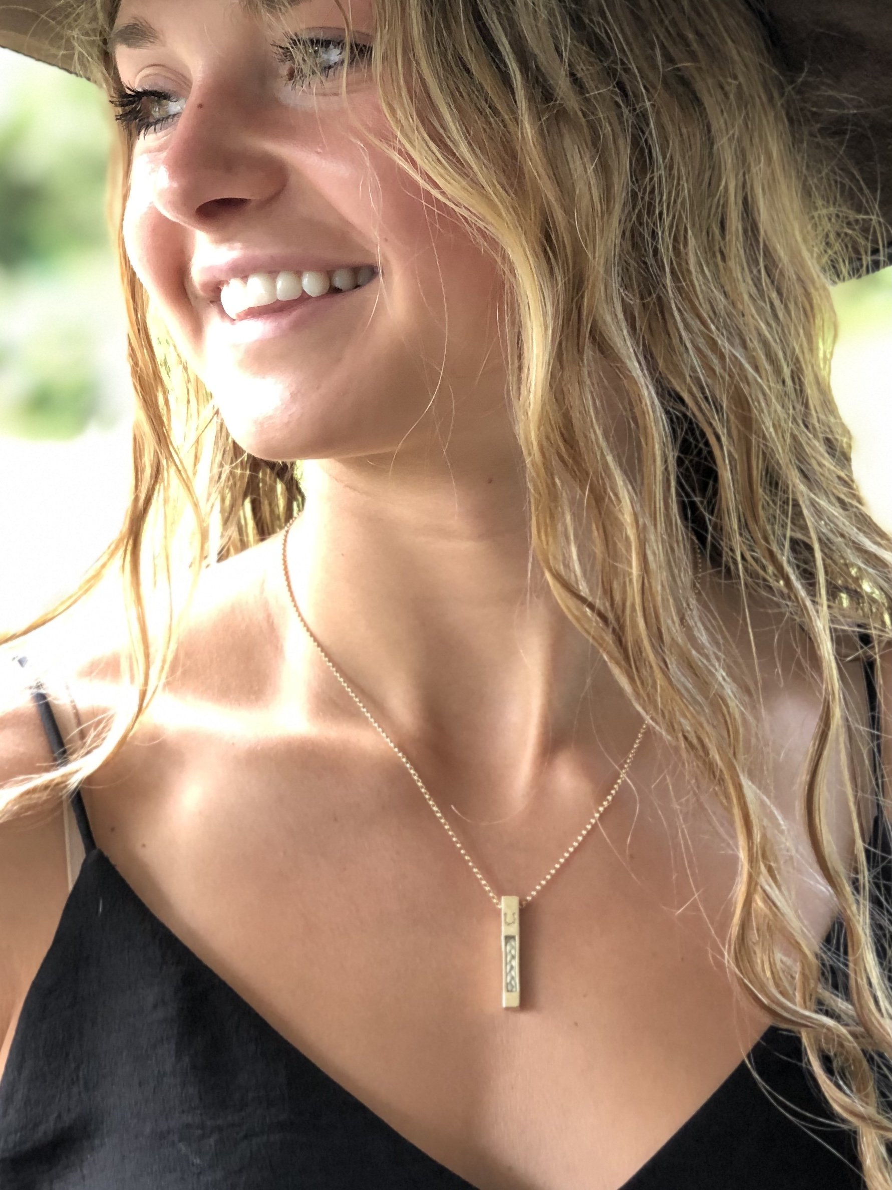 14Kt or 18Kt Gold Vertical Horse Hair Pendant and Chain Worn on a Woman's Neck