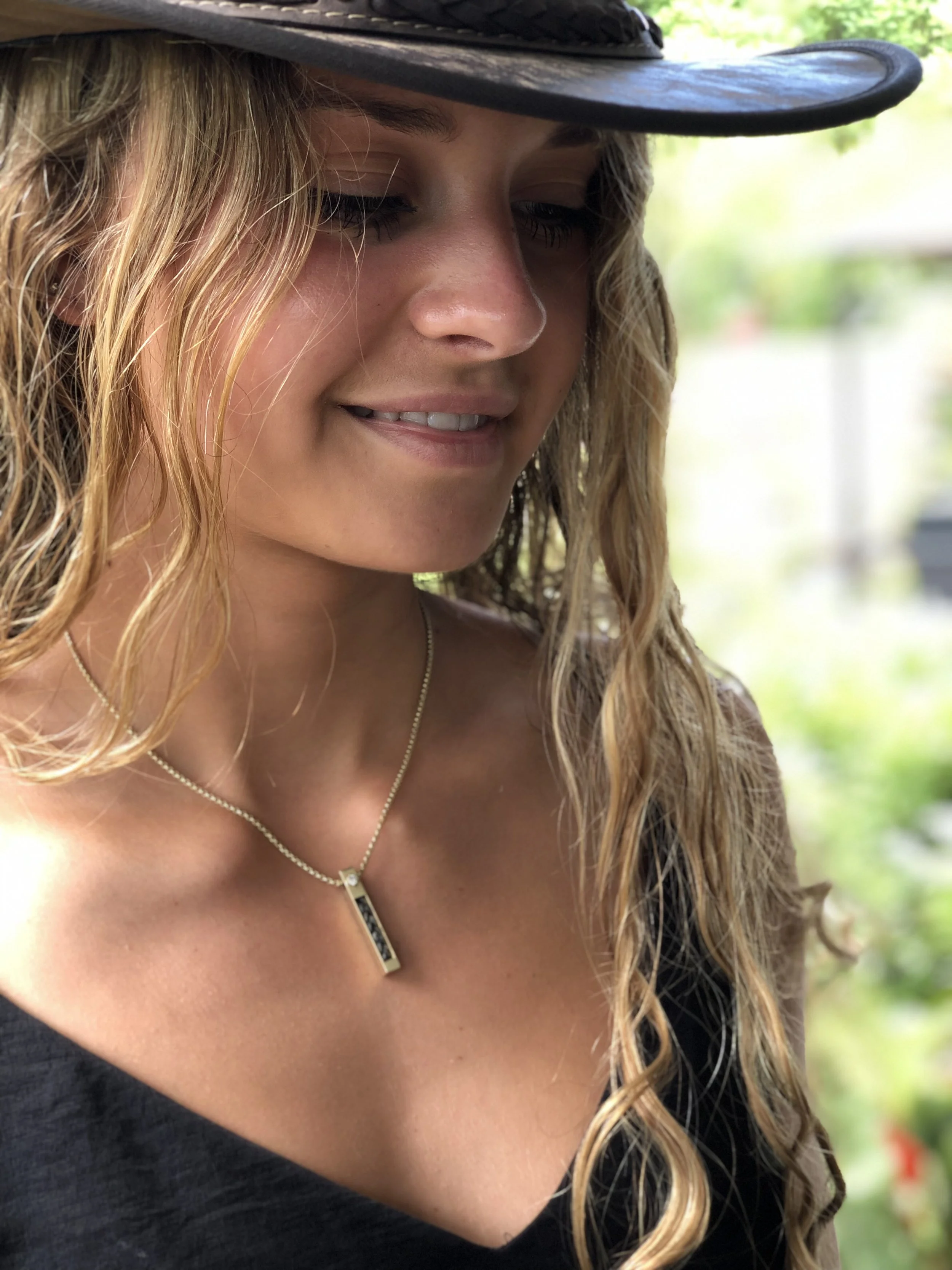 14Kt Gold Vertical Horse Hair Pendant with 3mm VS Diamond worn on person's neck