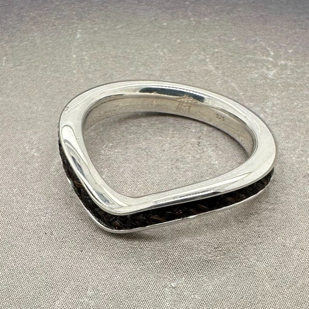 Sterling silver chevron horsehair ring with braided inlay, angled front view.