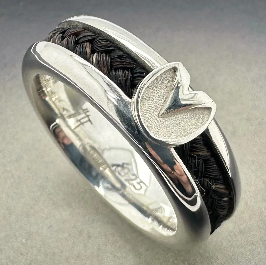 Custom sterling silver horsehair ring with barefoot hoofprint and optional engraving.