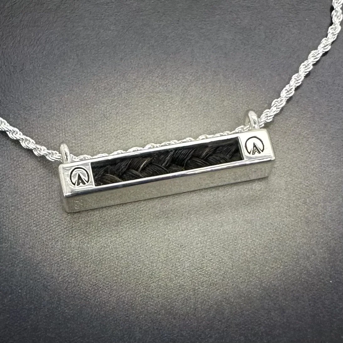 Sterling silver horizontal horsehair necklace with engraved barefoot hoofprints on each end of the bar pendant, braided black horsehair inlay.