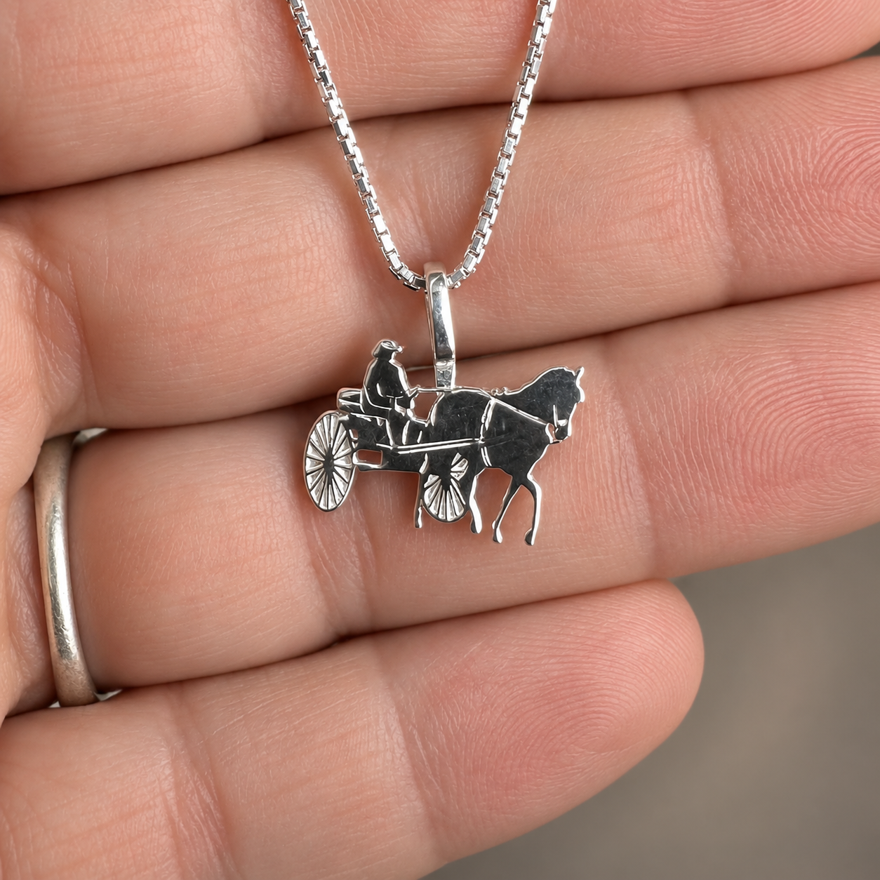 Silver Simple Bail Carriage Horse and driver Pendant in hand.png