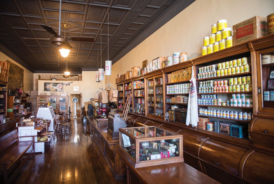   The interior of Watson’s Grocery Store Museum still includes the oak shelves, bins and counters. On the store’s back wall is an ice box, also made of oak.  Photo by Duane Tinkey 