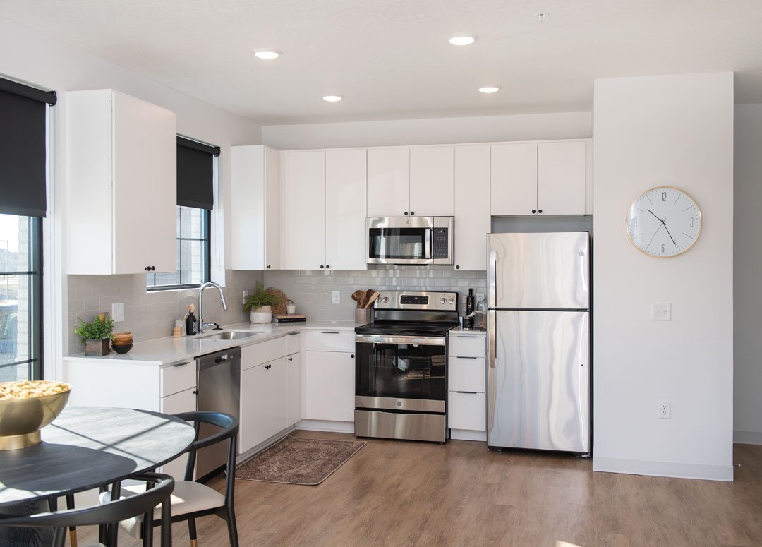   Kitchens at the Standard at 36th include stainless steel appliances and white cupboards and countertops.  Photo by Duane Tinkey 
