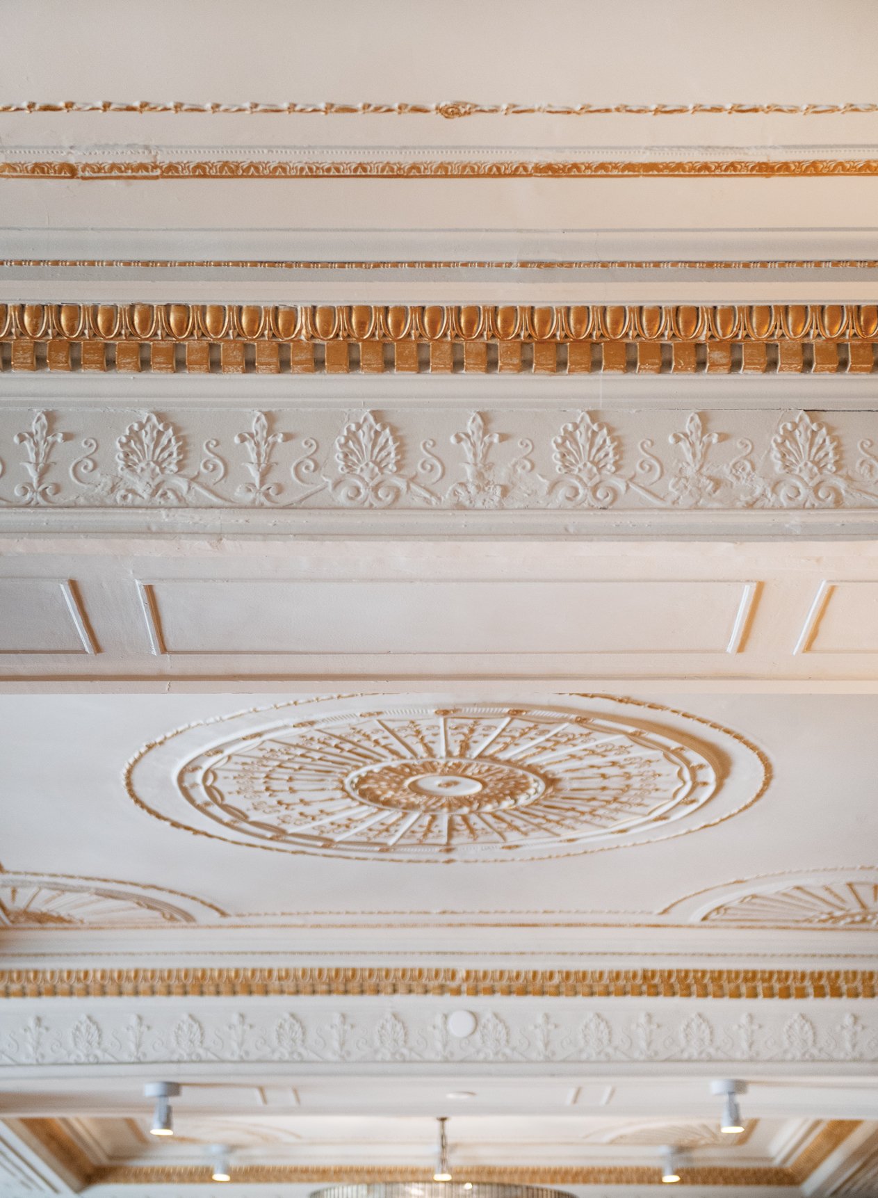  If you look closely at the ceiling in Proudfoot and Bird, you can see imperfections in the spacing of the intricate design, which is an indicator that it was completed by hand. The room was always the dining room of the hotel, and was at one time ca