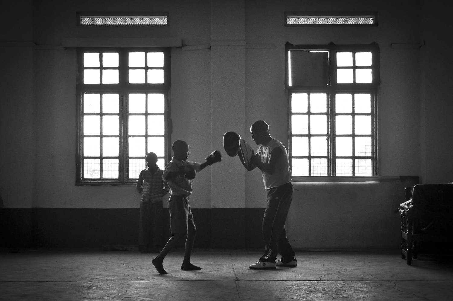 A young child trains with an adult at the Dallas gym in downtown Nairobi,