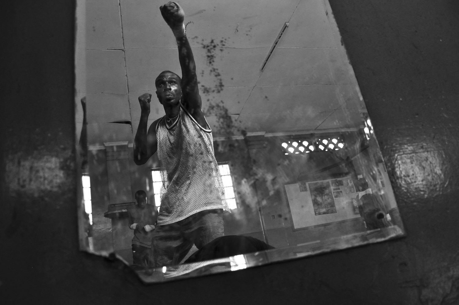 A boxer at Pamwani gym spars in front of a mirror while warming up for the day’s training session. Most of Kenya’s boxers fight in the lighter divisions. This is partly due to Kenyan’s natural physique, but also results from most boxers’ poor backgrounds and inadequate nutrition growing up.