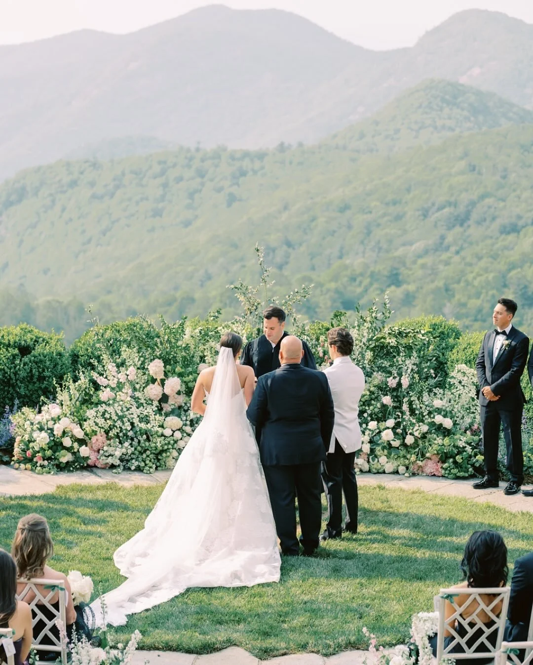 A mountain view fit for a fairytale .🤍 Emmalyne &amp; Carter&rsquo;s wedding day was nothing short of breathtaking &mdash; from the ceremony on the overlook to a tented garden reception dripping in tulips and timeless details. Romance, elegance, and