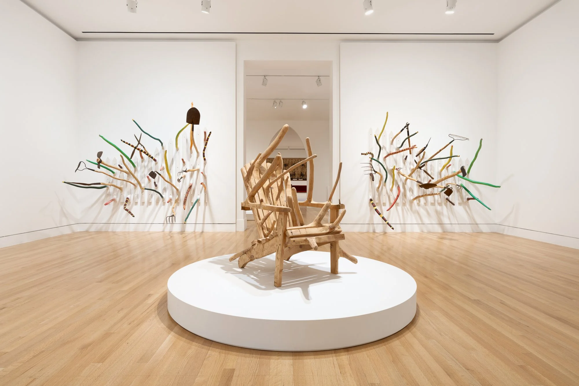 various wood sculptures in a gallery