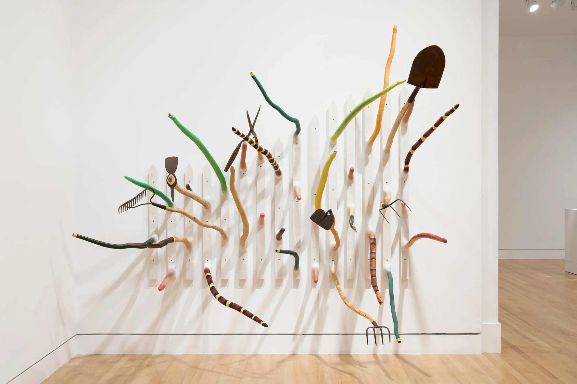 a wood sculpture on a white wall