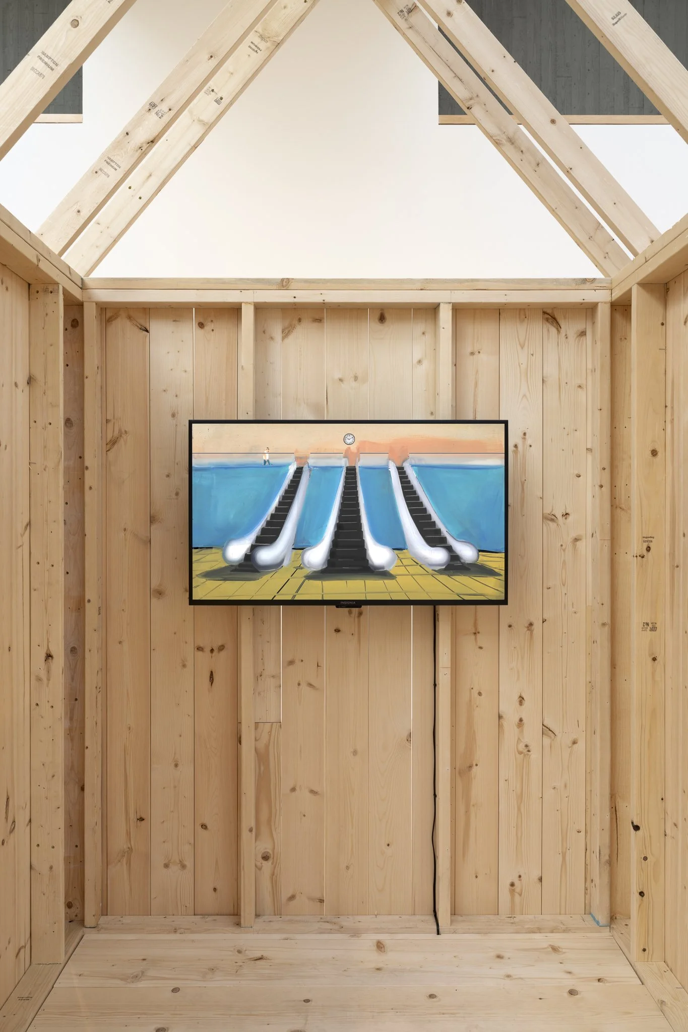 a wooden shed with a flat screening showing three escalators