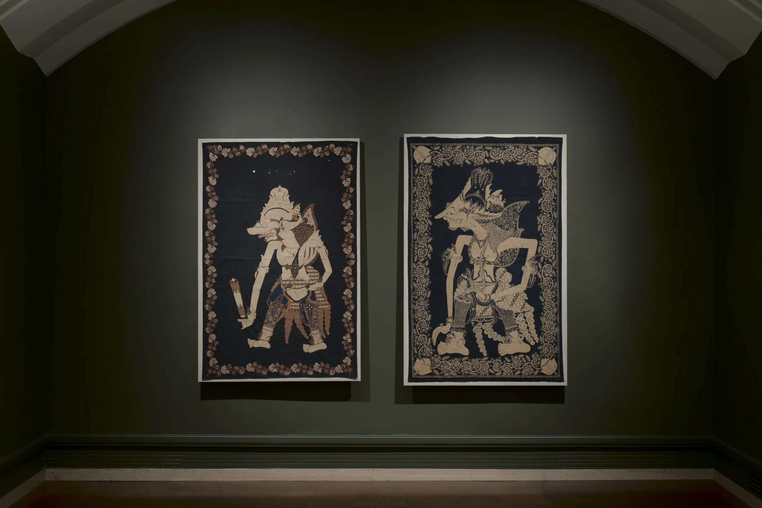 two paintings of figures in a dark green room