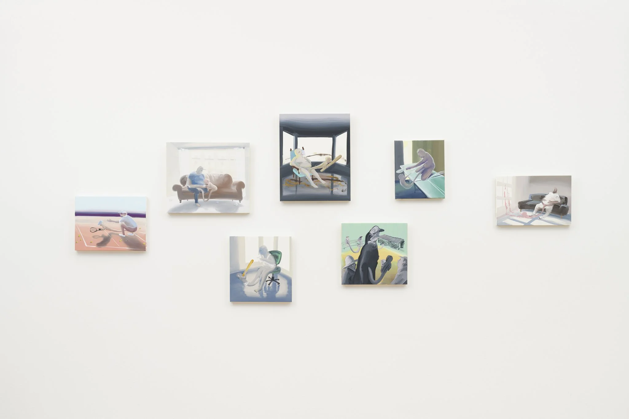 7 paintings hung on a wall in a cluster