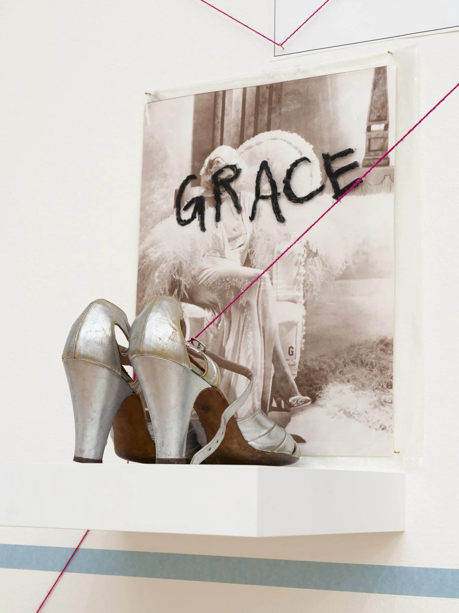 an image with the text "GRACE" behind a pair of shoes