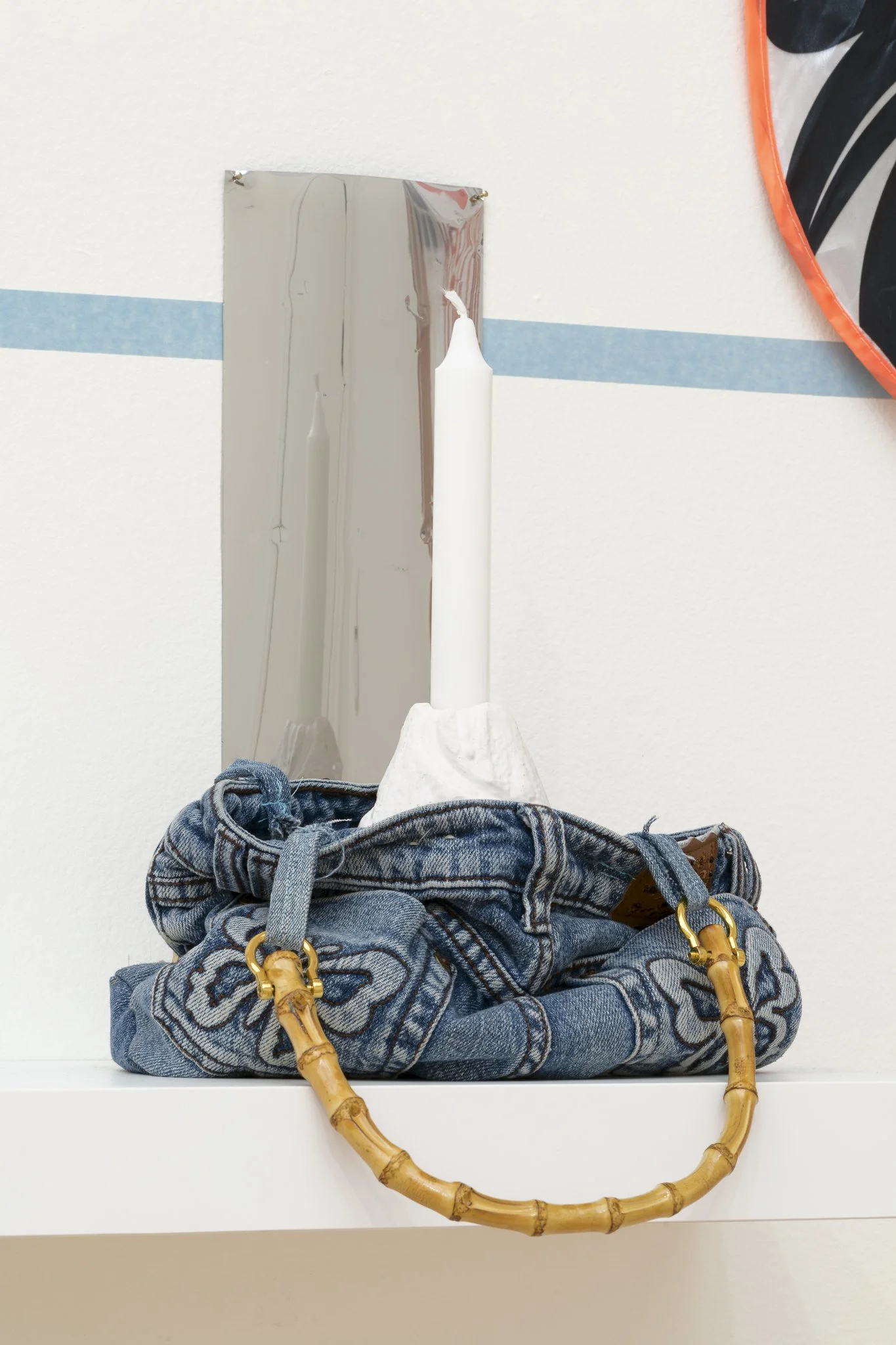 a candle inside of a handbag in the shape of jeans