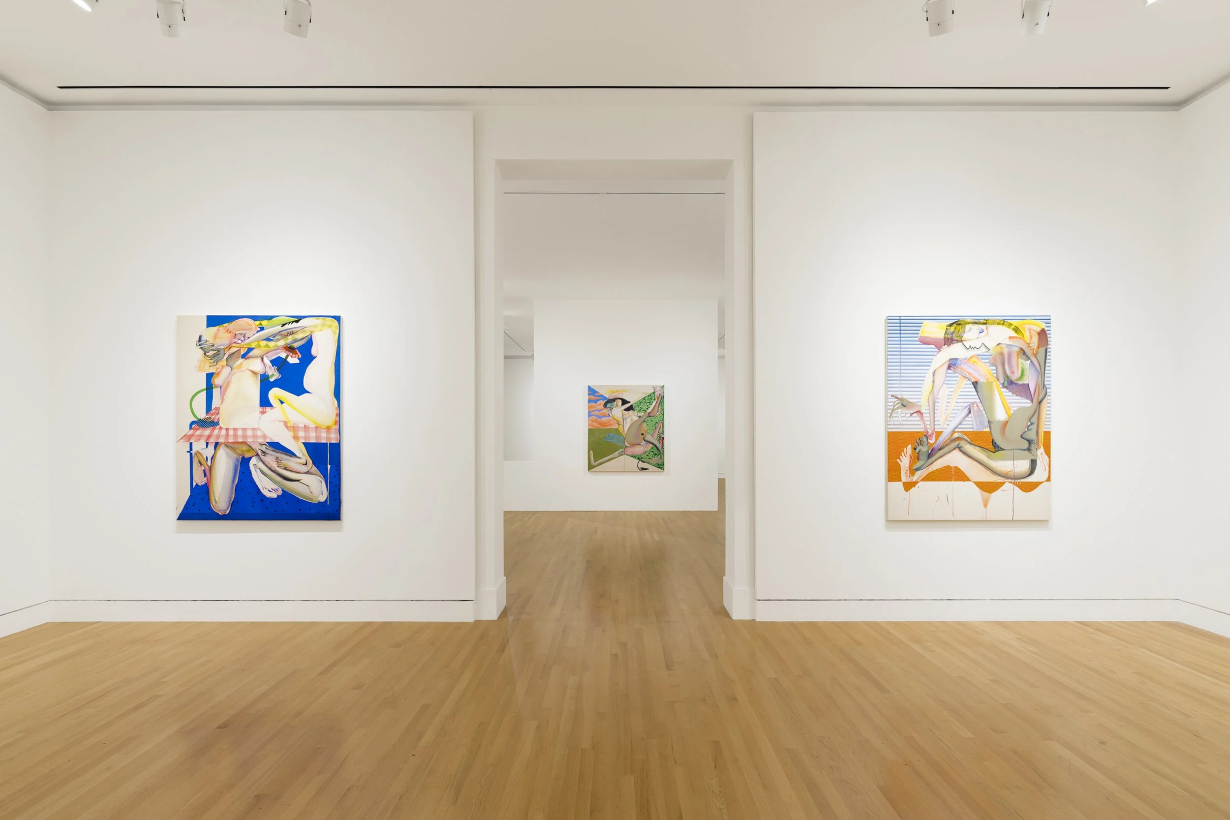 three abstract paintings in a gallery