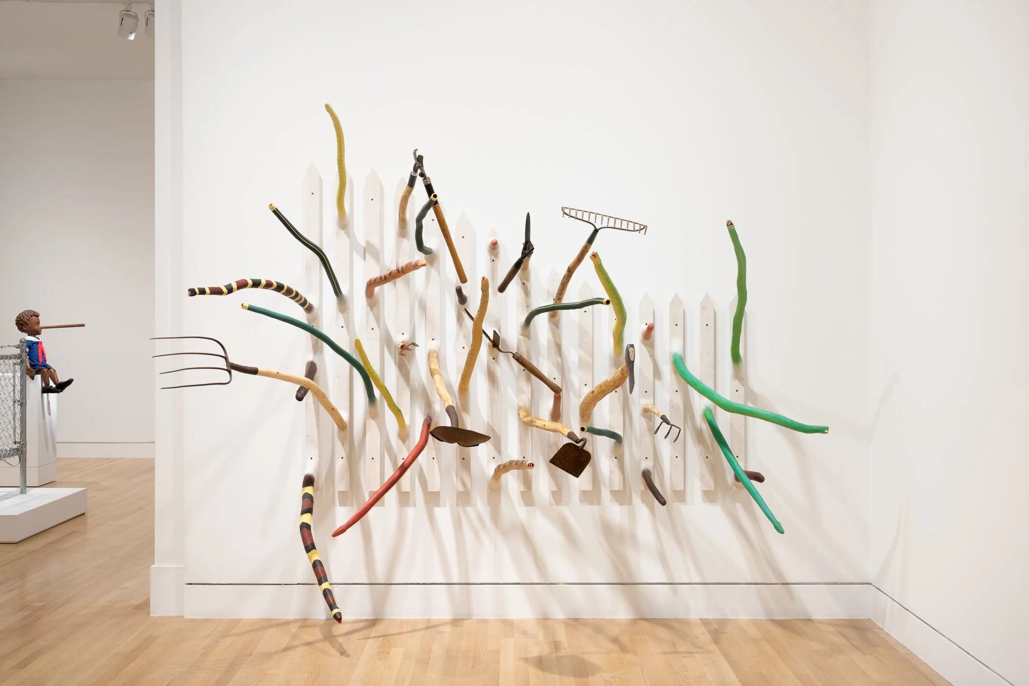 a wood sculpture on a white wall