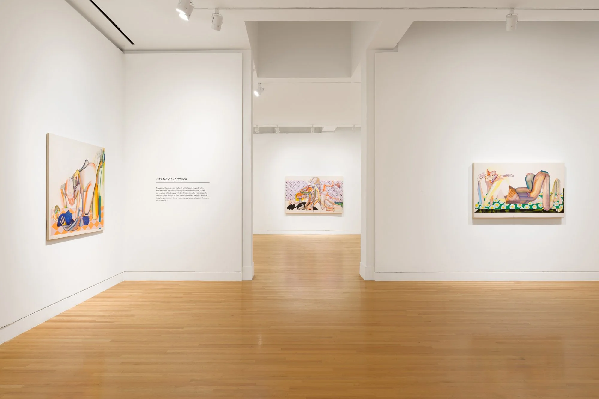 many abstract paintings in a gallery