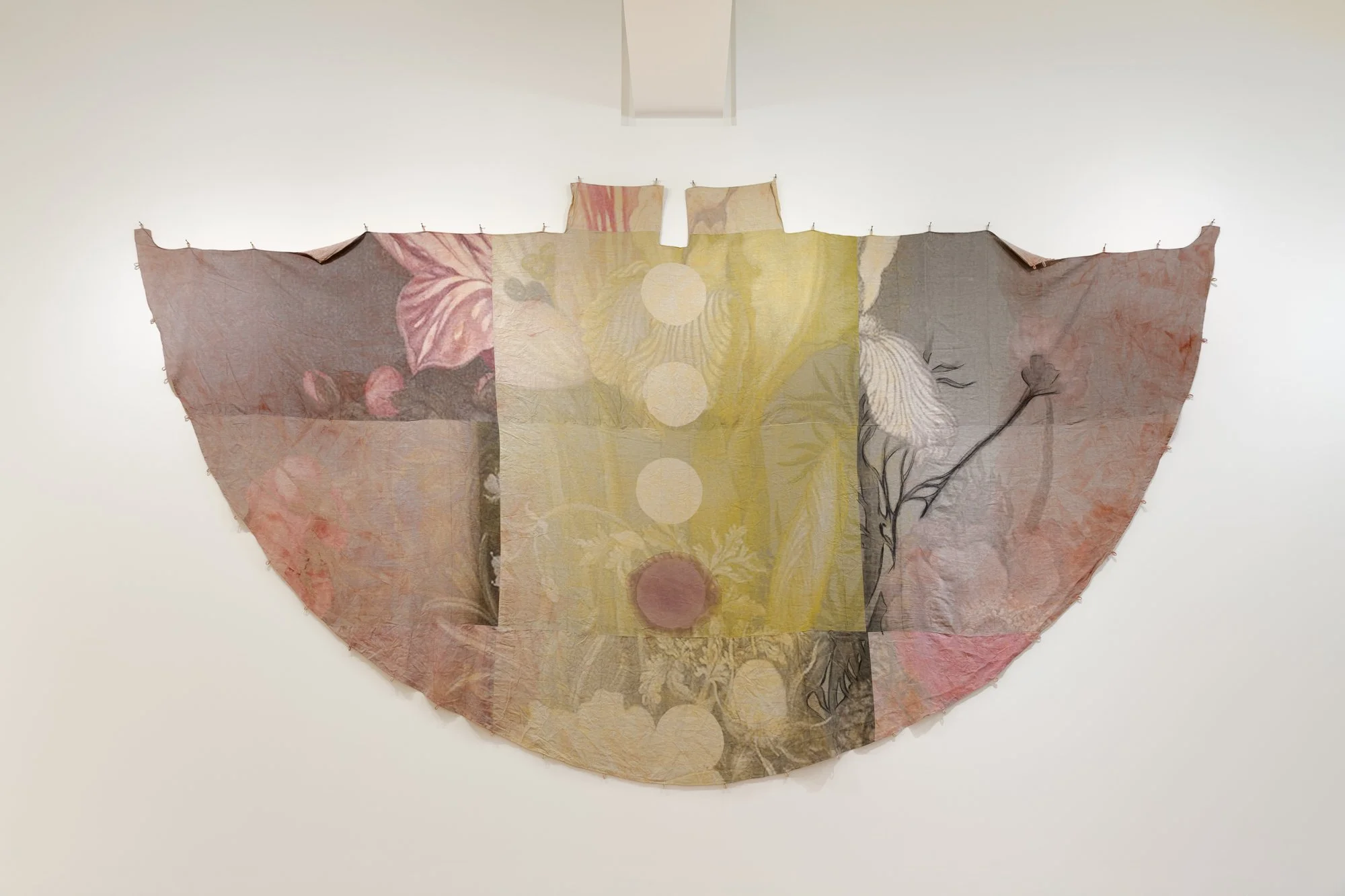 a large textile piece on a wall in the shape of a teepee cover