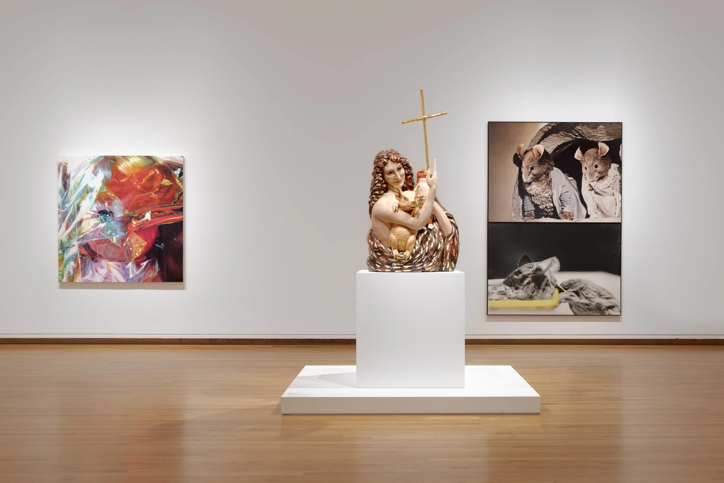 two paintings and a sculpture in a gallery