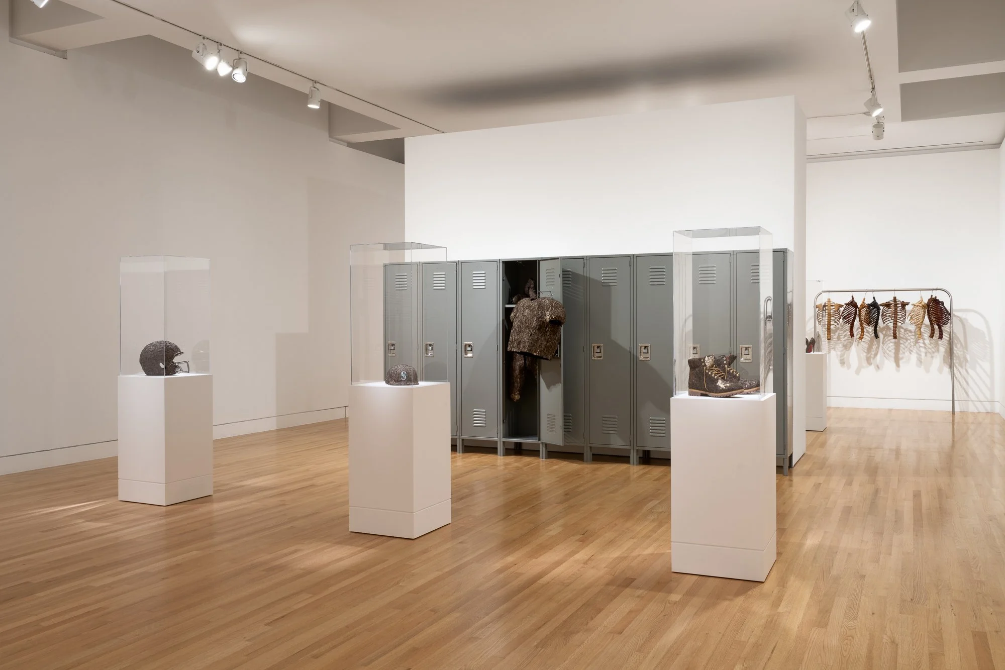 various sculptures and a roll of lockers in a gallery