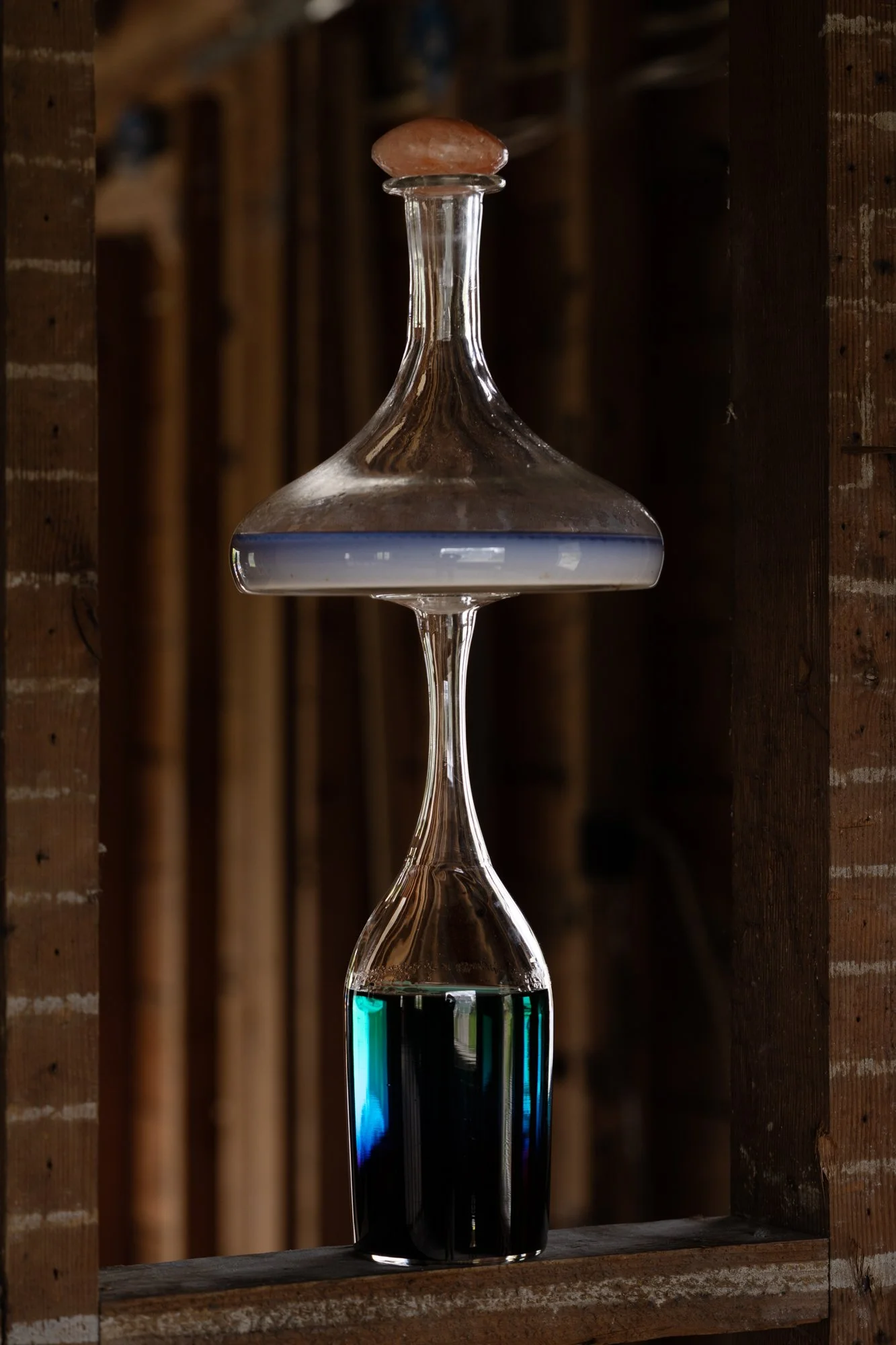 a sculpture made of glass vessels and colorful liquids