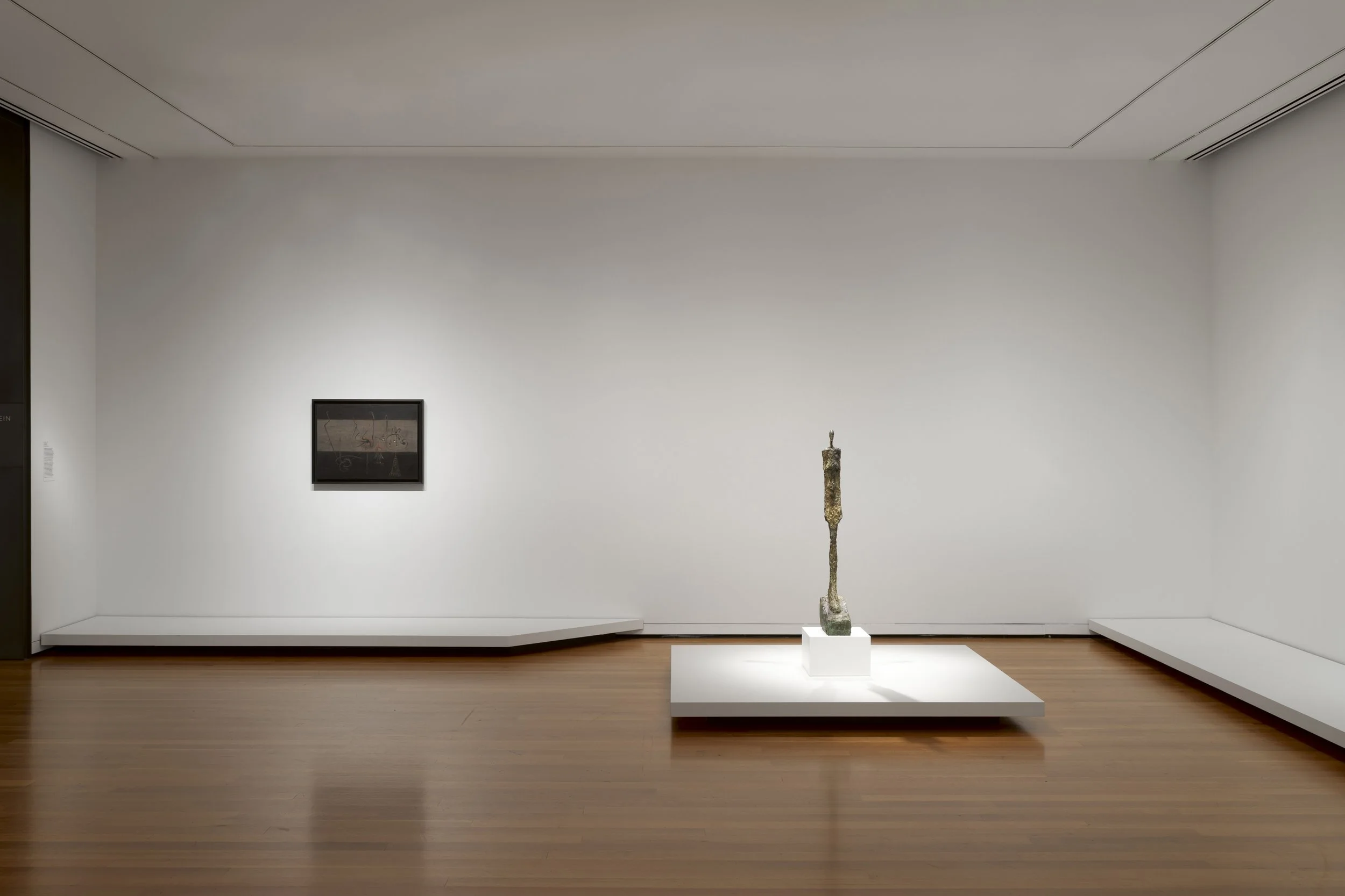 a sculpture and a painting in a gallery