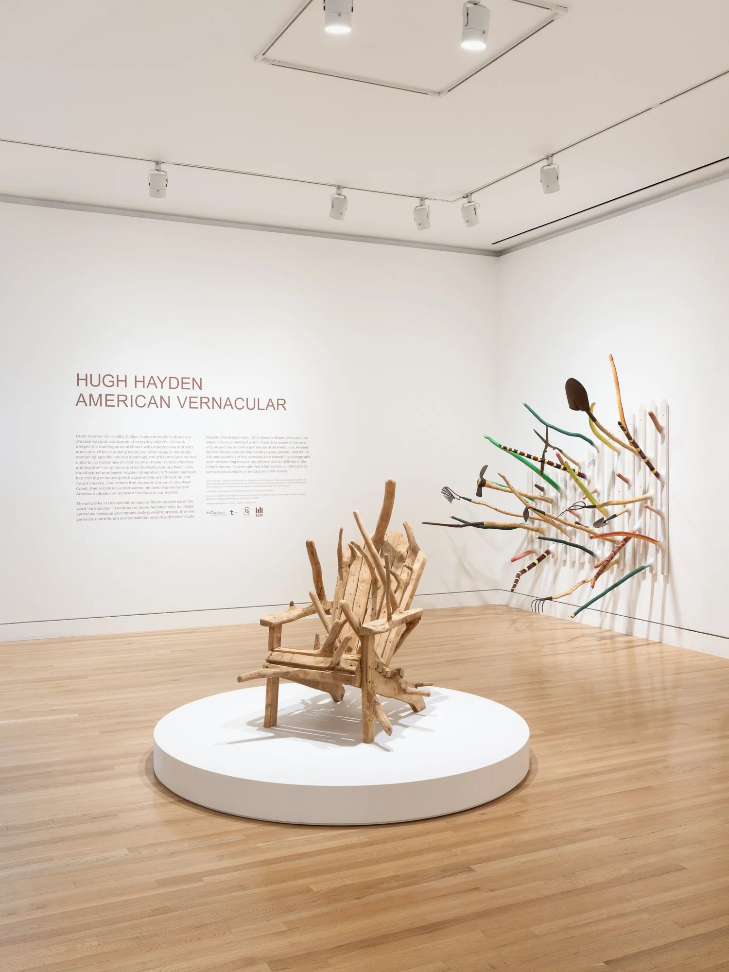 two large wood sculptures in a gallery
