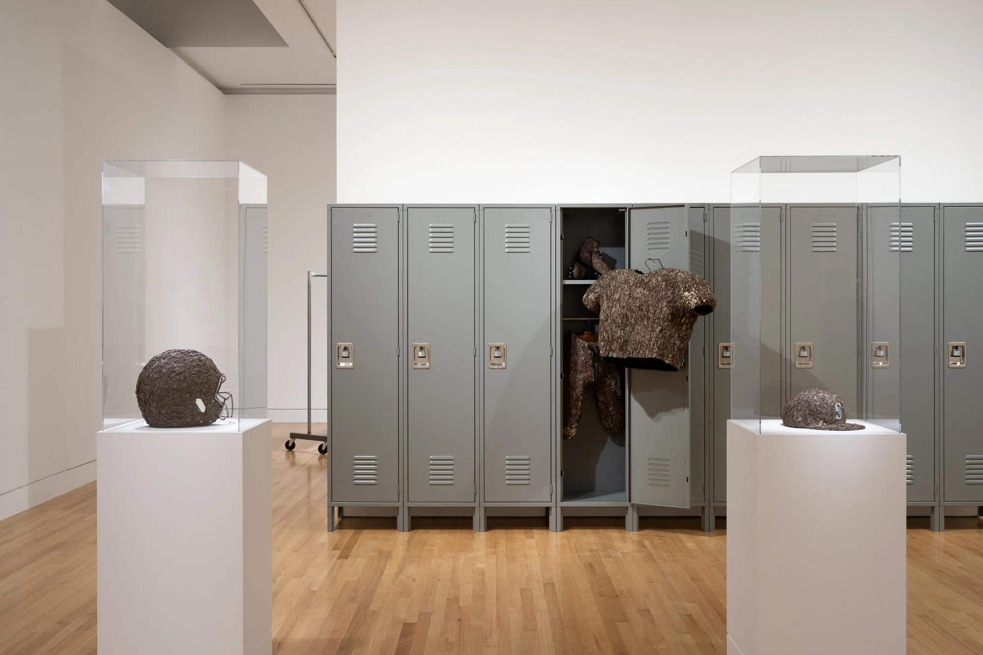 various sculptures and a roll of lockers in a gallery