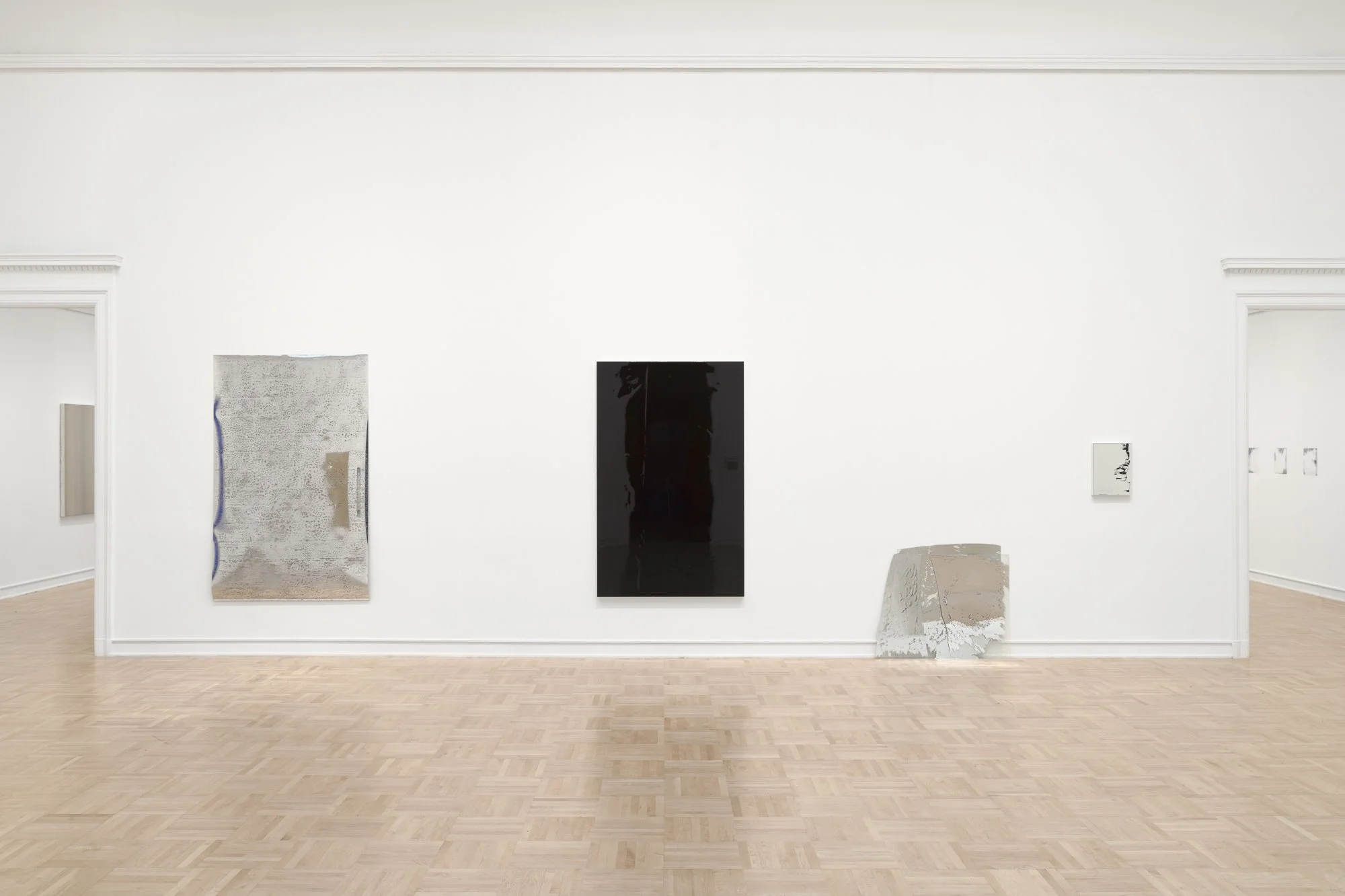 various monochrome artworks in a gallery