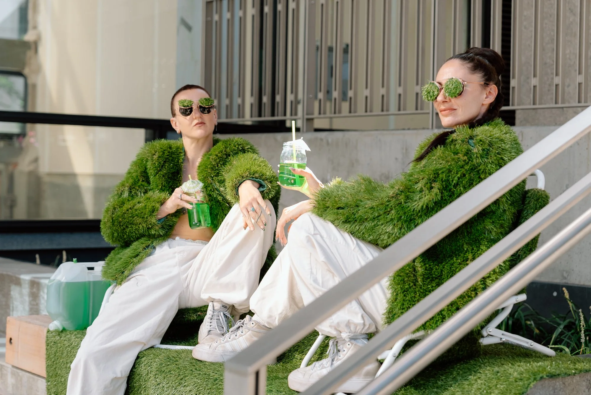 two performers in costumes made of fake grass