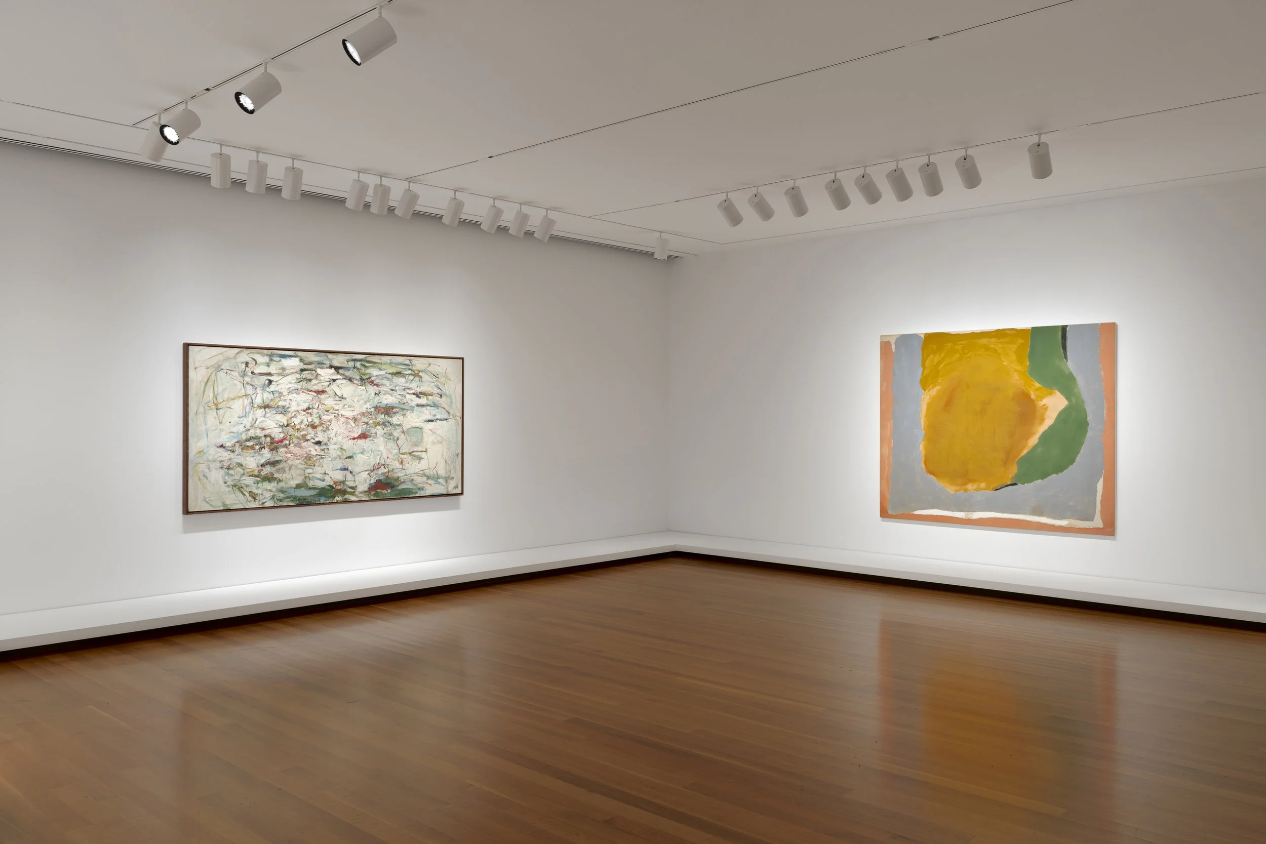 two large paintings in a gallery