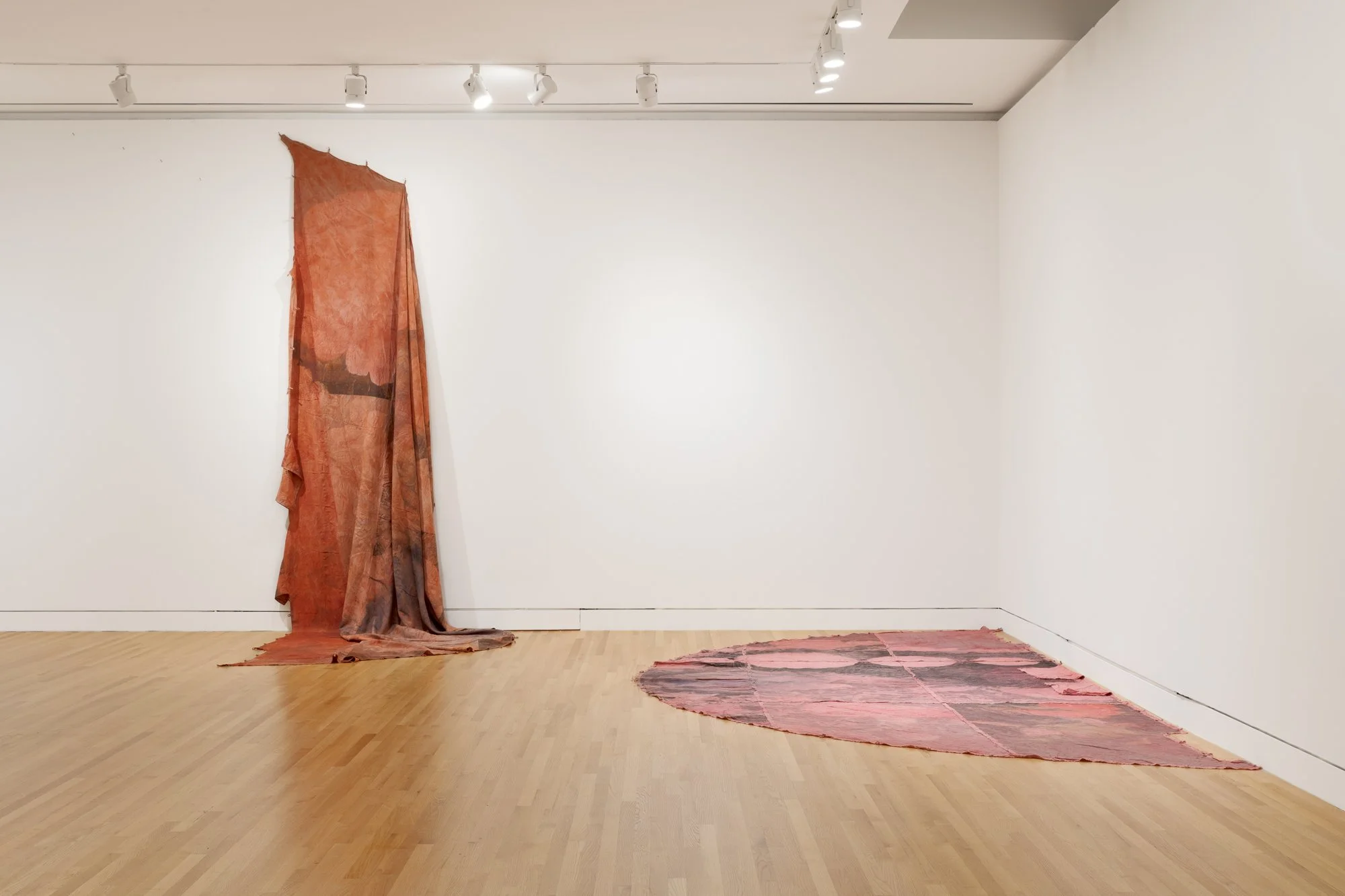 various large textile works in a gallery