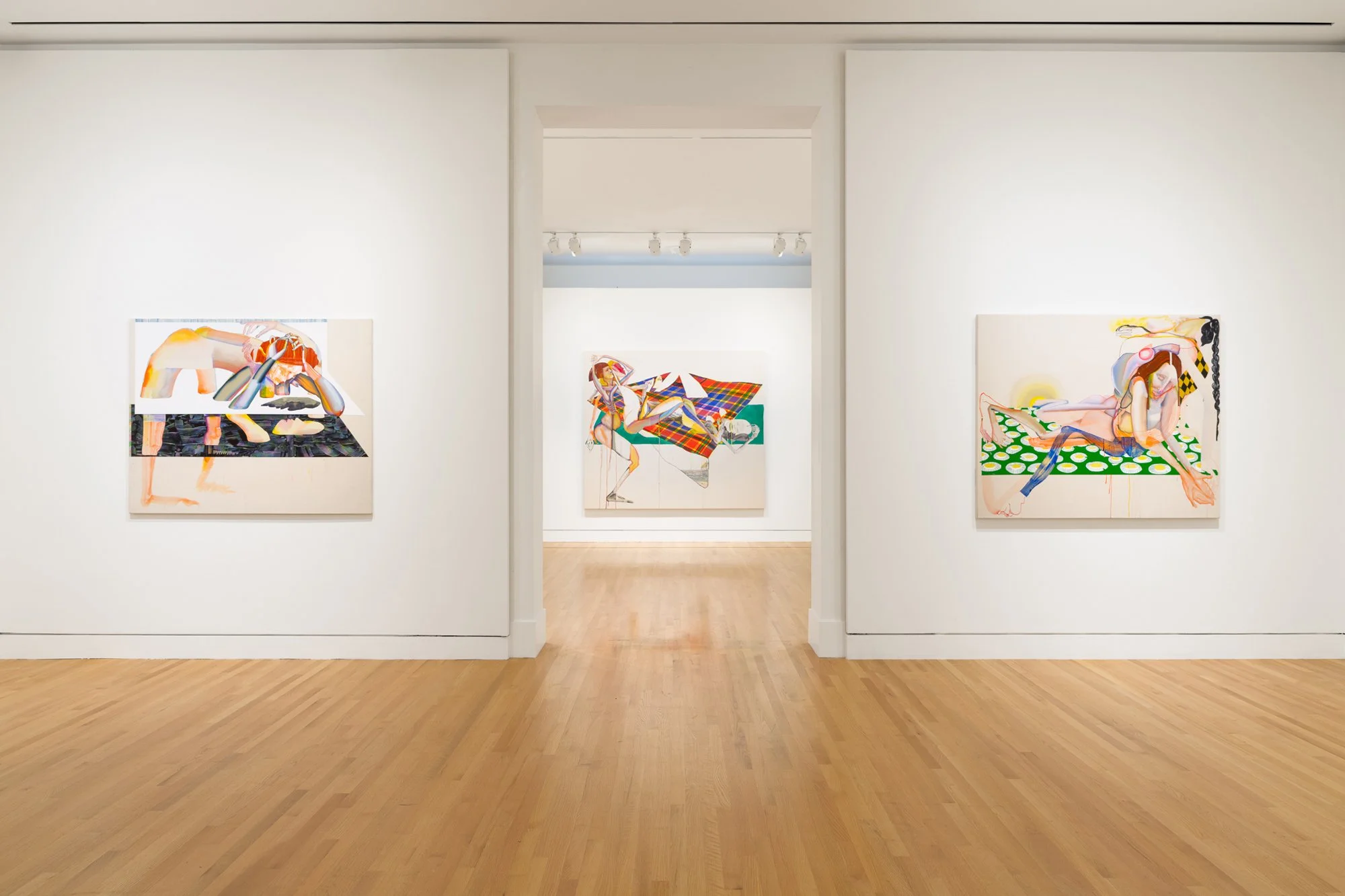 three abstract paintings in a gallery