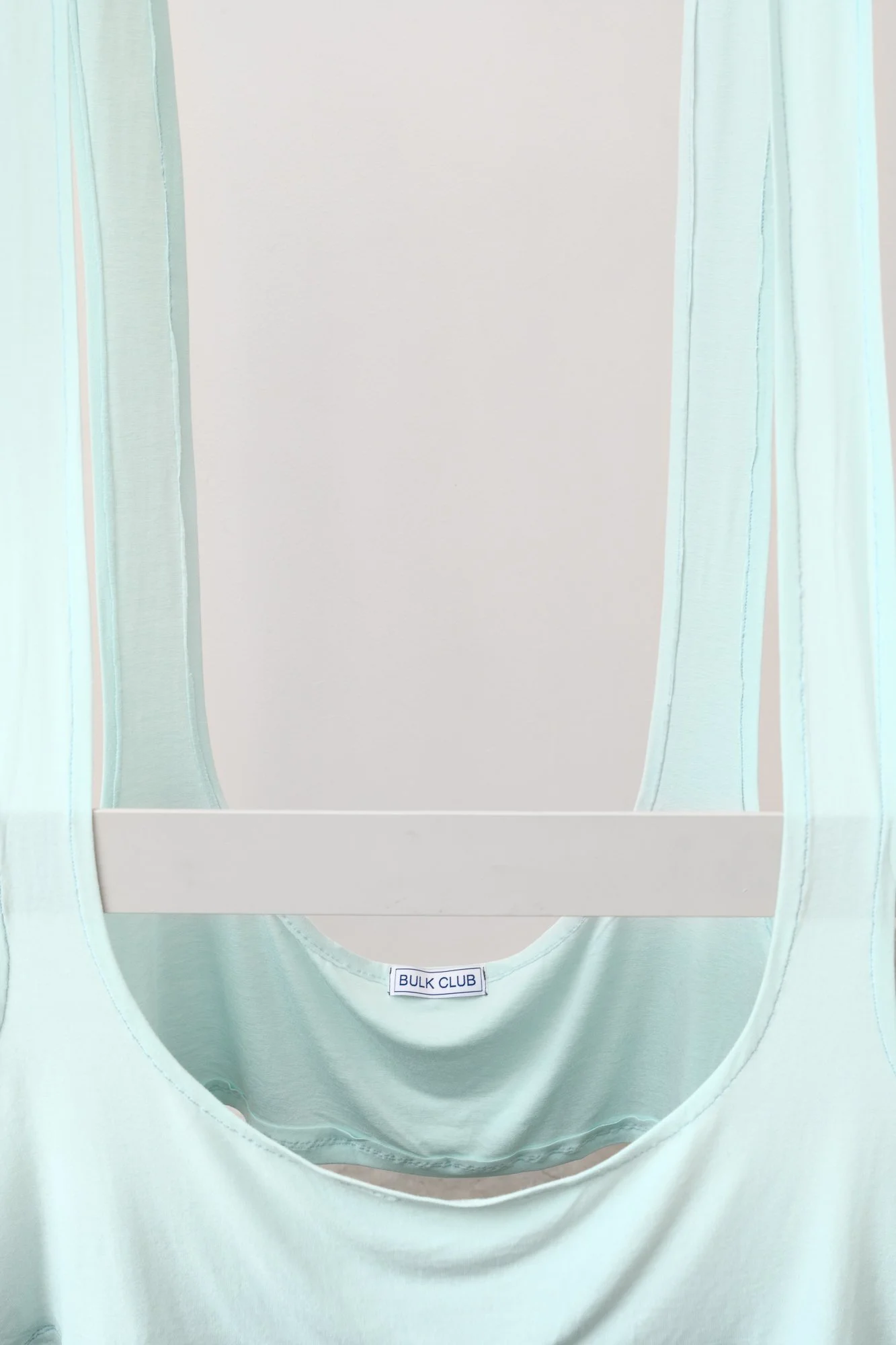 large blue tank top hung on a structure